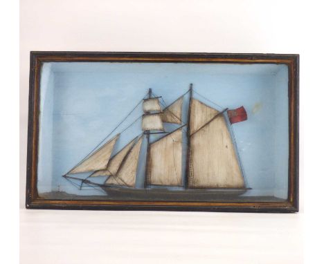 A late 19th/early 20th century deep box picture with scene depicting a half wooden model of a twin-masted sailboat 'Katie', o