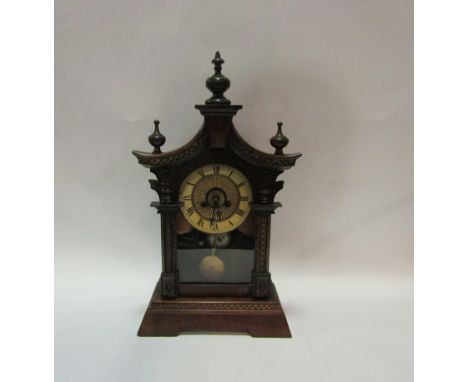 A circa 1900 walnut cased bracket clock of stylised pagoda form, Roman numerated chapter ring, finial detail