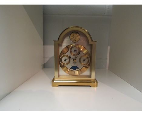 A Bulova quartz Tempus Fugit mantel clock with month, day and date dials