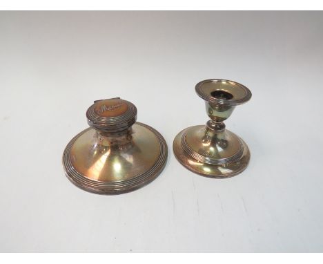 A silver capstan inkwell and a silver candlestick (2)