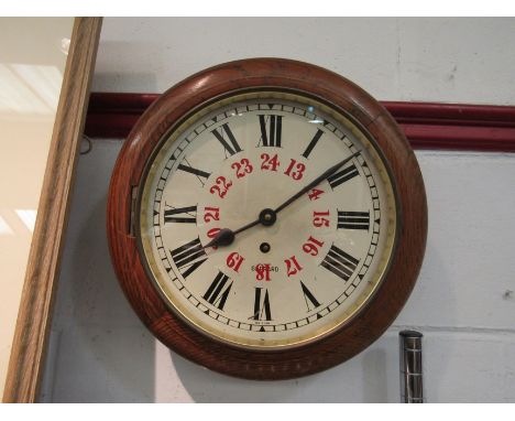 A Garrard oak cased circular wall clock, Roman numeral dial with key and pendulum