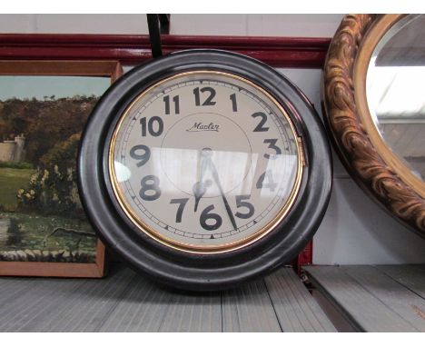 A Master dial clock with ebonised case and Arabic numerated dial