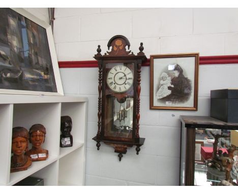 A late 19th Century walnut cased Vienna wall clock with marquetry inlay and turned spindle detail, Roman numerated chapter ri