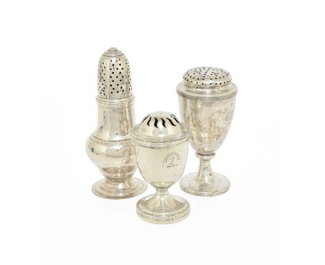 Three Various George II and Later Silver Pepperettes, one baluster and on spreading foot, engraved with a crest, London, 1755