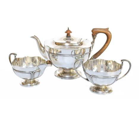 A Three-Piece George V Silver Tea-Service, by Reid and Sons, London, 1913, each piece tapering and on spreading foot, compris