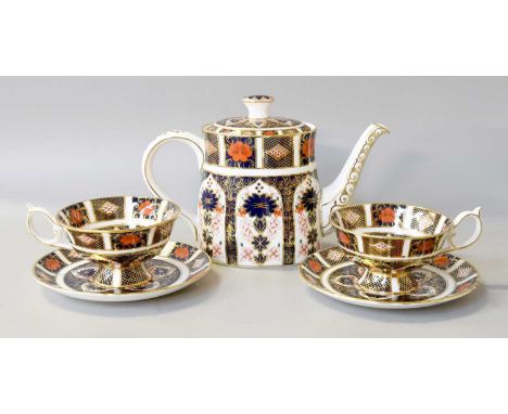 A Royal Crown Derby Porcelain Teapot and Cover, with breakfast cups and saucers en suite, Imari pattern 1128 Teapot - 15cm hi