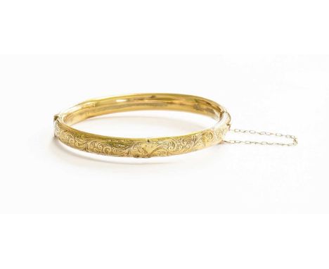 A 9 Carat Gold Hinged Bangle, with engraved decoration to the upper section, inner measurements 6.0cm by 5.1cm (a.f.)Gross we