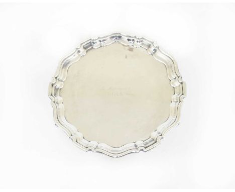 An Elizabeth II Silver Waiter, by Sucking Ltd., Birmingham, 1961, in the George III style, shaped circular and on three scrol