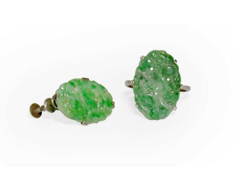 A Jade Ring and A Single Earring, the ring formed of an oval pierced jade plaque, in white claw settings, to a plain polished