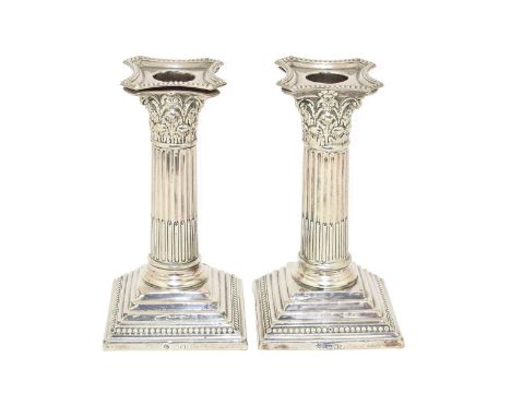 A Pair of Edward VII Silver Candlesticks, by William Hutton and Sons Ltd., London, 1906, each on stepped and beaded square ba