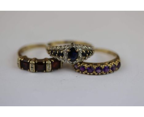 Three gem set 9ct yellow gold rings comprising amethyst seven stone 9ct yellow gold ring, seven small round mixed cut amethys