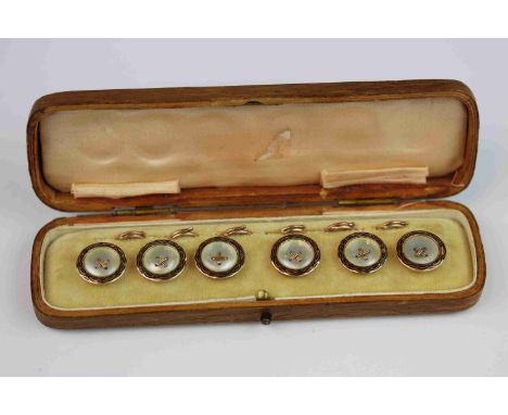 Mother-of-pearl enamelled 9ct rose gold button set comprising six buttons, the circular mother-of-pearl panel with black enam