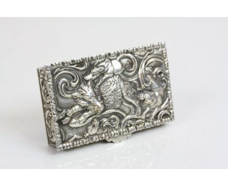 Spanish silver table snuff box, the hinged lid depicting hounds attacking a boar amongst foliate scrolls, cast and repousse, 