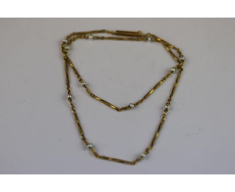 Baroque pearl yellow metal necklace, twelve small baroque pearl beads suspended between fine link chain and twisted bar links