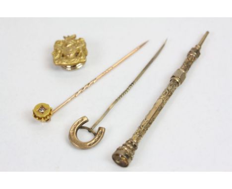 Diamond set unmarked yellow and rose gold stick pin, rose metal horse shoe stick pin, a gilt metal propelling pencil with eng