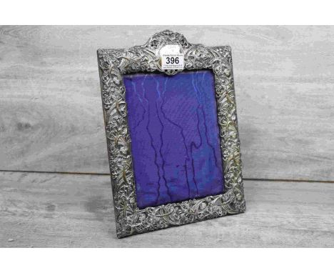 Edwardian silver easel back photograph frame, Irish scrolling floral decoration in relief, initialled cartouche, makers Henry