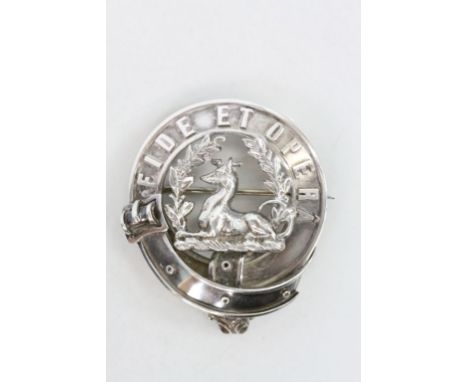 Edwardian Scottish silver clan badge depicting the MacArthur family crest of a greyhound couchant with two branches of bay an