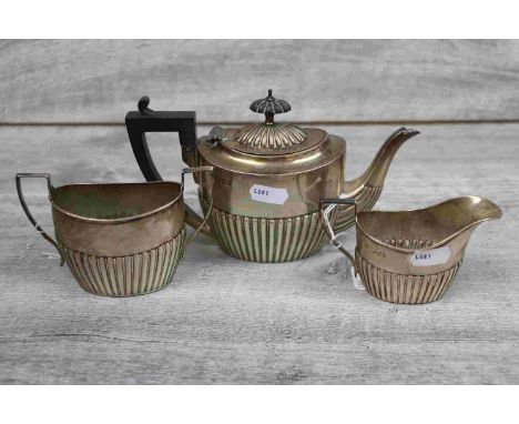 Late Victorian matched silver three piece bachelor tea service comprising teapot, twin handled sugar bowl and milk jug, each 