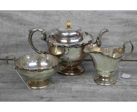 Edwardian three piece silver tea service comprising tea pot, sugar bowl and milk jug, each bearing cast floral and foliate sc