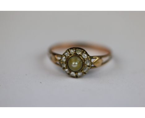 Early 20th century pearl and diamond 9ct rose gold cluster ring, the central conical cream pearl with rub over setting and sm
