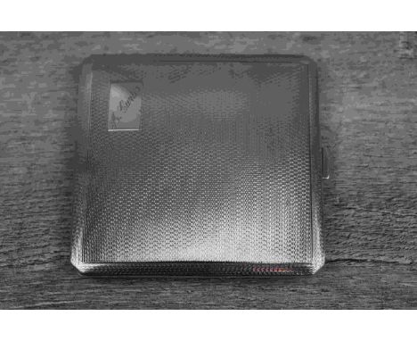 Silver cigarette case of square form with engine turned decoration to front and verso, engraved cartouche, gilt interior, mak