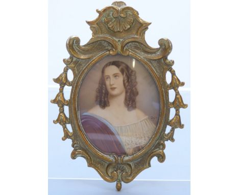 19thC portrait miniature of a lady in ornate brass frame, indistinctly signed possibly Opic, maximum diameter 8cm