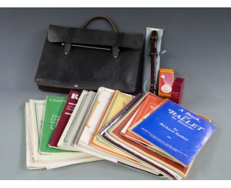 A vintage leather music case containing viola, piano and recorder music together with a Wittner, German travelling metronome 