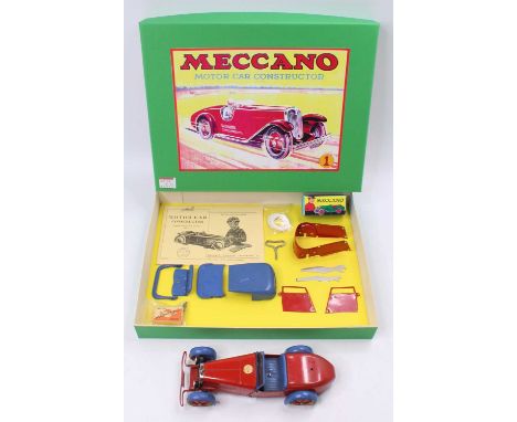A Meccano No. 1 constructor's car, comprising of red &amp; blue body with a quantity of associated components, some reproduct