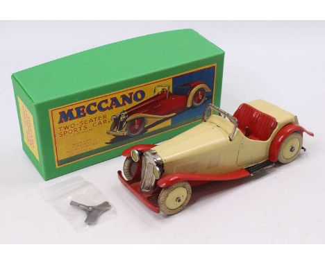 A Meccano No. M223 Non-Constructor's two-seater sports car, comprising of red &amp; cream body with clockwork mechanism, hous