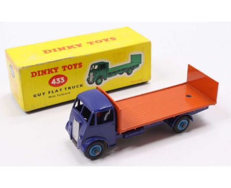 Dinky Toys No. 433 Guy Flat Truck comprising of a dark blue cab and chassis with light blue hubs and orange back, housed in t