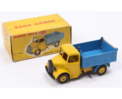 Dinky Toys No. 410 Bedford End Tipper Truck, yellow cab and chassis with yellow hubs and blue back, in the original all card 