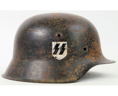 SS HELMET: An original WWII Nazi Third Reich era SS Helmet. With SS emblem to to right side. Impressed number 3409 to rim.