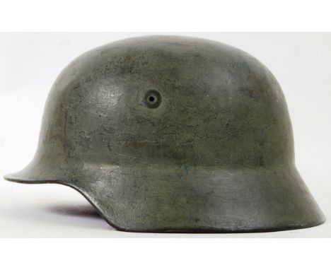 NAZI HELMET: An original WWII Second World War era NAzi Third Reich uniform helmet, in green. Name of soldier painted to rim 