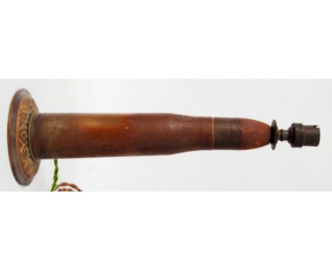 TRENCH ART LAMP: A very unusual early 20th century lamp, the stem being made from a brass shell casing. Decorative circular b