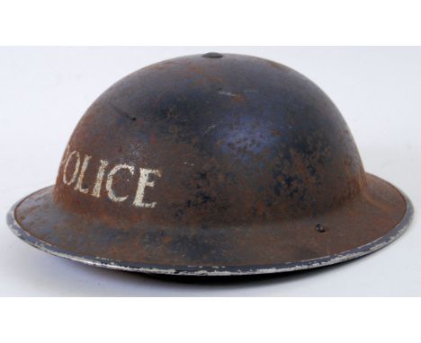 POLICE HELMET: A WWII Second World War era British Police tin helmet, with white notation to front and original leather liner