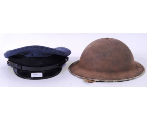 HEADWEAR: Two vintage military hats - including a second world war era tin helmet and an RAF style peaked cap. No insignia. T