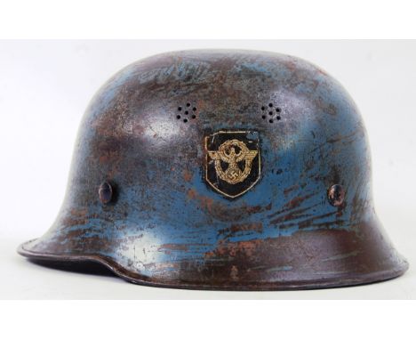 THIRD REICH POLICE HELMET: An original WWII Second World War era Nazi third Reich Police helmet. Eagle emblem to side, blue. 