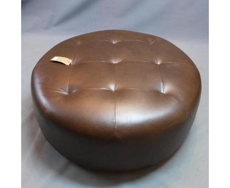 A contemporary black leather pouffe. 