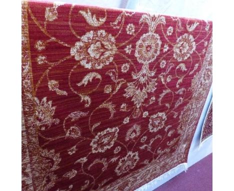 A Zeigler style carpet with floral design on a red ground contained by beige ground border. 230x160cm 