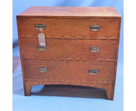 An Arts and Crafts chest of three graduated drawers raised on bracket feet. H-84 W-92 D-53 cm 