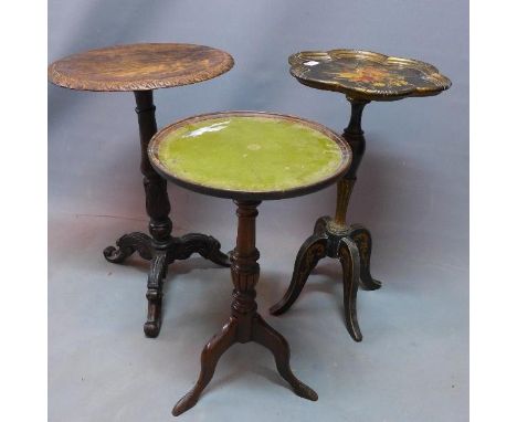 An early 20th century ebonised lamp table with hand painted floral decoration together with an oak and a mahogany example. 