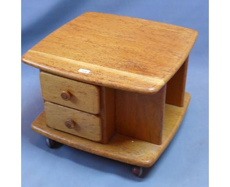 A 20th century light oak coffee table with four drawers and shelf space, raised on castors. H-43 W-58 D-58cm 