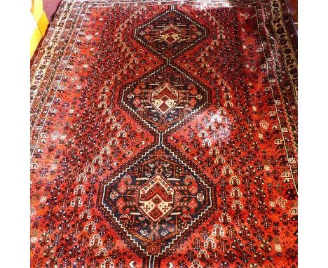 A fine South West Persian Qashqai carpet, 290cm x 216cm, triple pole medallion within repeating petal motifs on a terracotta 