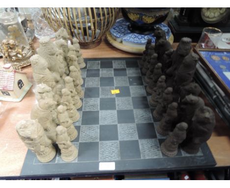 An animal themed cast chess set with hand worked slated games board