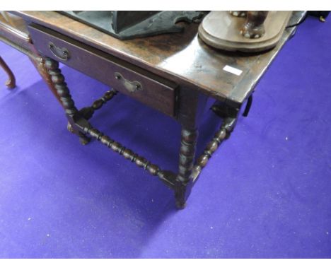 A composite 19th and 20th century oak side table in the Jacobean style having frieze drawer and bobbin frame