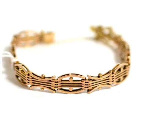 A gold bracelet stamped 10ct, of fancy gate link form 