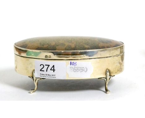 A silver and tortoiseshell mounted oval trinket box, raised on four scroll feet