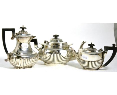 A Mappin & Webb silver teapot; together with a similar bachelors silver teapot; and a Scottish silver hot water pot (3) 