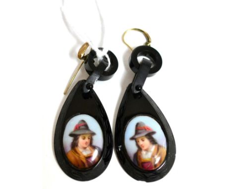 A pair of jet earrings, each set with an oval portrait of a man to oval jet frames with carved decoration and suspended from 