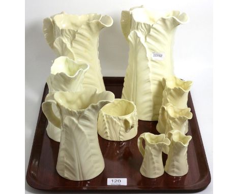 Eight graduated Royal Worcester leaf moulded jugs and a sucrier 